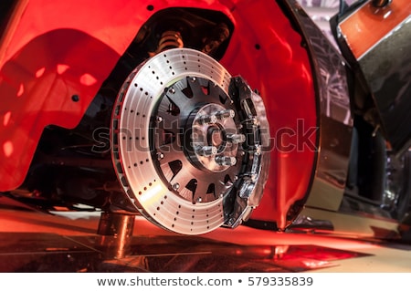 Mechanic Examining Brake Disc Of Car In Garage Stockfoto © cla78