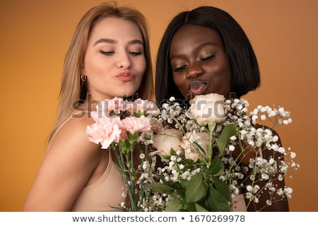 Foto stock: Close Up Of Happy Lesbian Couple With Flowers