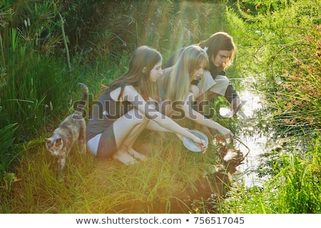 ストックフォト: Young Man And Women Catching Tadpoles