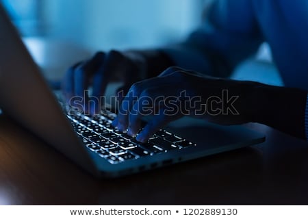 Stockfoto: Hacker With Coding On Laptop Computer In Dark Room