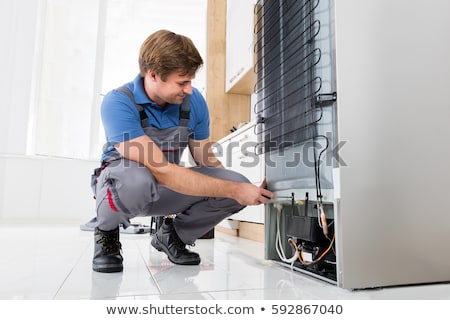 Stock fotó: Serviceman Checking An Refrigerator
