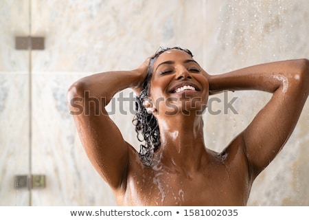 Foto stock: Woman Taking A Long Hot Shower Washing Her Hair