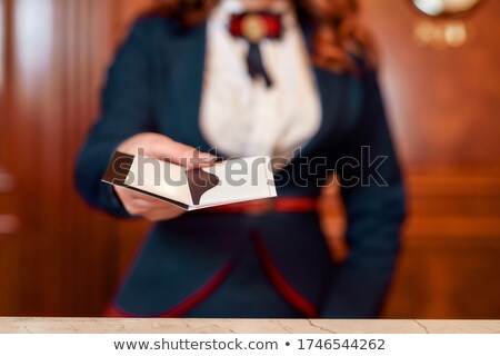 ストックフォト: Crop Guest Giving Card To Receptionist