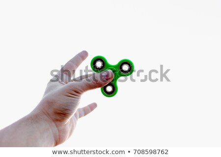 Stockfoto: Close Up Of A Mans Hand Who Is Holding A Fidget Spinner In A Park