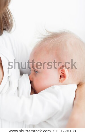 Stock photo: Mother Breastfeeding Her Baby Against A White Background