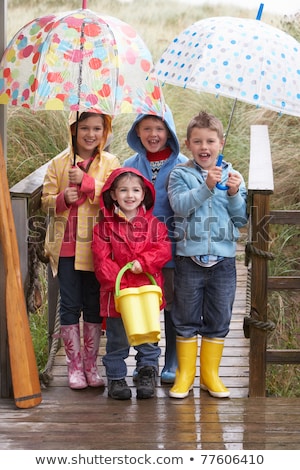 ストックフォト: Boy Standing On Footbridge With Umbrella