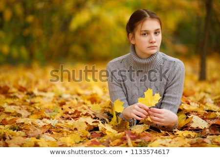 Stock photo: Young Reddish Woman Lying In Autumn Leaves