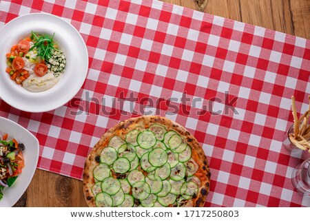 Stock photo: Whole Grain Pizza With Vegetables And Fresh Salad On A White Plate Selective Focus