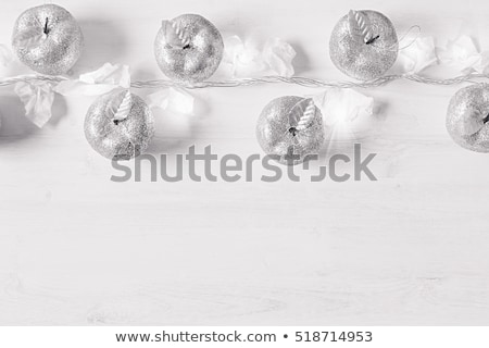 Stock fotó: Christmas Soft Home Decor Of Silver Apples And Lights Burning In Boxes On A Wooden White Backgroun