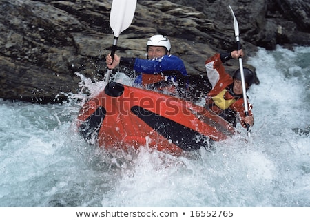 [[stock_photo]]: Eux · personnes · pagayant · bateau · gonflable · vers · le · bas · des · rapides