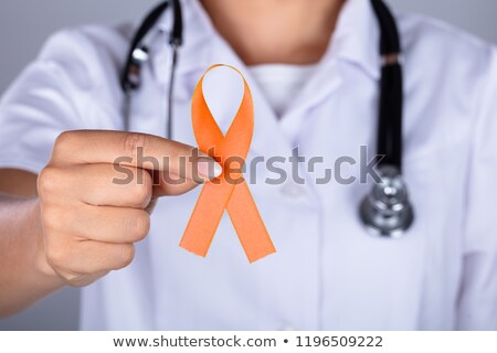 Foto d'archivio: Doctor With Ribbon Showing Uterine Cancer Awareness