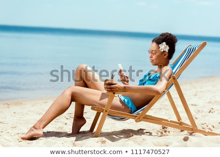 Foto stock: Young Attractive Woman Relax On The Sea Beach