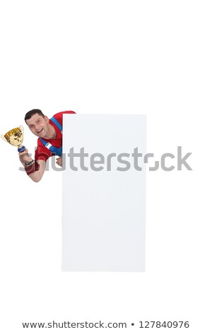 Stockfoto: Man Holding A Trophy Behind A White Blank Square