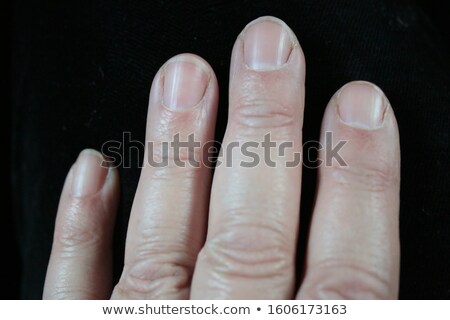 Stockfoto: Four Feet In A Bed Against A White Background