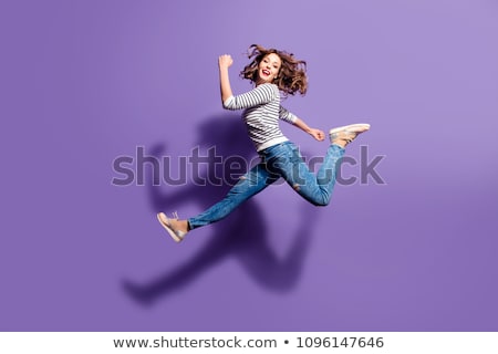 Stock photo: Young Woman Jumping In Air