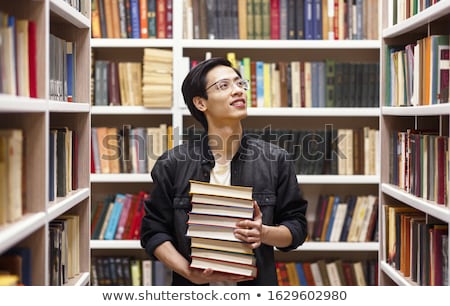 Foto stock: Portrait Of A Man With Glasses In A Bookstore