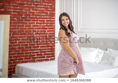 Foto d'archivio: Happy Young Plus Size Woman Posing In Pink Dress