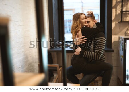 ストックフォト: Side View Of Attractive Couple Hugging And Sitting In Cafe