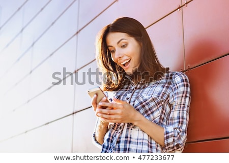 Foto stock: Successful Young Businesswoman Using Smartphone And Holding Docu