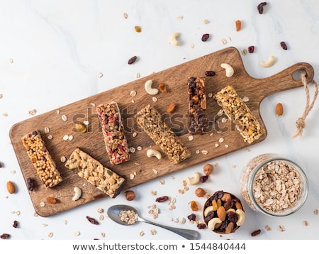 ストックフォト: Organic Cereal Granola Bar With Berries On Marble Board With Honey Spoon And Jar Of Oats And Linen T