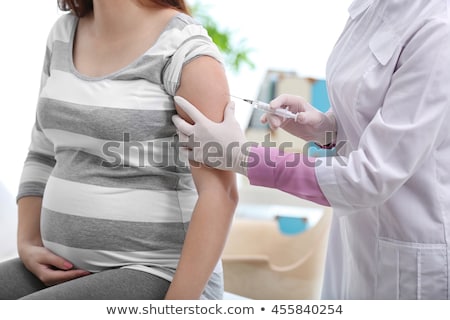 Foto stock: Doctor Vaccinating A Pregnant Woman