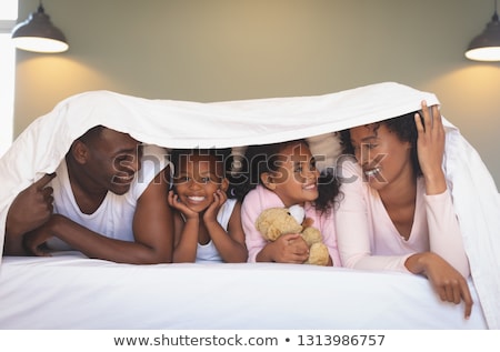 Stock foto: Front View Of Happy African American Family Under Blanket And Taking Selfie With Mobile Phone On Bed