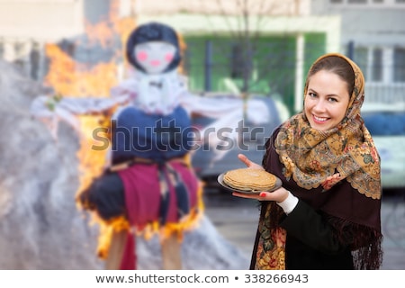 Stock foto: Maslenitsa Russian Young Woman In Traditional National Dress Bakes Pancakes Russian Holiday Shrovet
