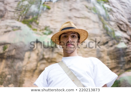 Stock fotó: Young Man Enjoying In Natural Park At The Base Of Large Waterfal