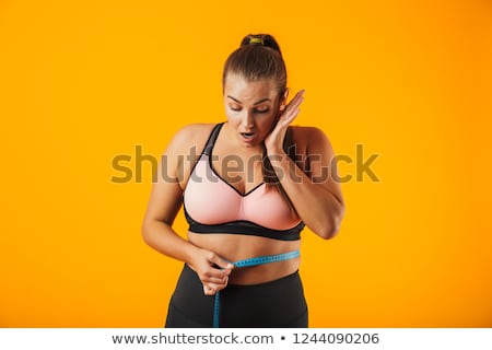 [[stock_photo]]: Portrait Of Chubby Sportswoman In Sportive Bra Measuring Her Wai