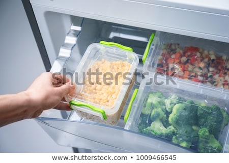 Foto d'archivio: Woman Taking Food From Refrigerator