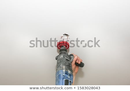 Zdjęcia stock: Man Drilling Hole In Ceiling