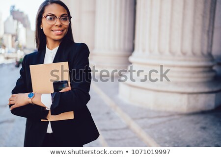Stock photo: Gorgeous Black Businesswoman On The Phone Holding Folder