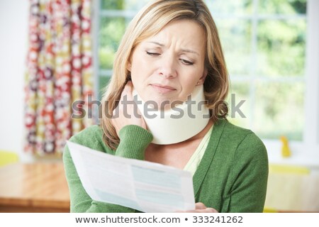 Foto d'archivio: Woman Reading Letter After Receiving Neck Injury