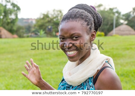 Foto stock: Woman Smiling In A Hut In A Park