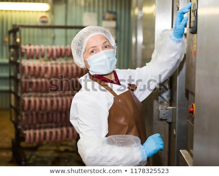 Stockfoto: Butcher Operating Machine At Meat Factory