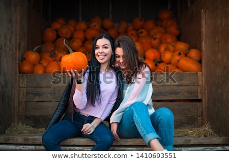 Foto stock: Fashionable Beautiful Young Girl At The Autumn Pumpkin Patch Bac
