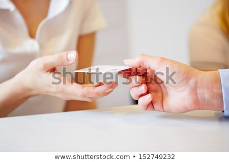 Stok fotoğraf: Patient Giving Credit Card To Receptionist In Clinics To Pay For Medical Service