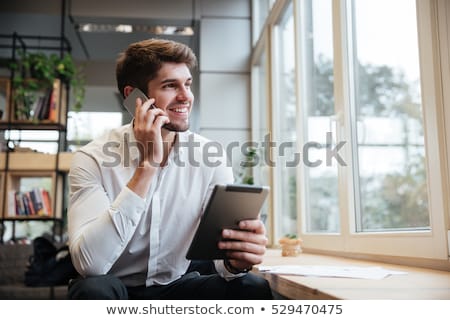 Foto stock: Young Man Talking On Phone