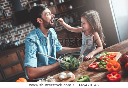 Stok fotoğraf: Woman Making And Tasting Vegetable Salad