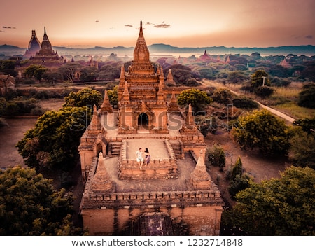 Foto stock: Buddhist Pagoda Silhouette And Balloon At Sunrise Bagan Myanmar