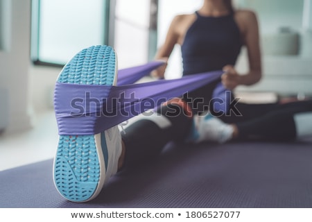 Stok fotoğraf: Pilates Woman Rowing Rubber Band Exercise