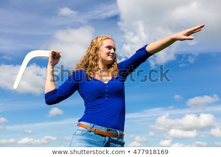 Stockfoto: Dutch Woman Throwing Boomerang In Blue Sky