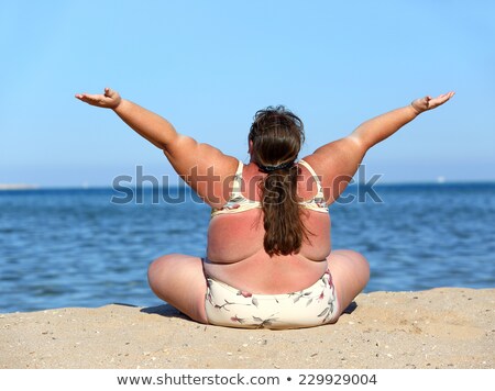 Foto stock: Overweight Woman Sitting On Beach