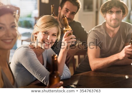 Foto stock: Portrait Of Men With Bottled Beer At Pub