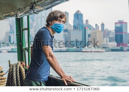 Foto stock: A Young Man On A Ferry In Hong Kong