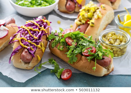 Foto stock: Hot Dog With Vegetables Lettuce And Condiments