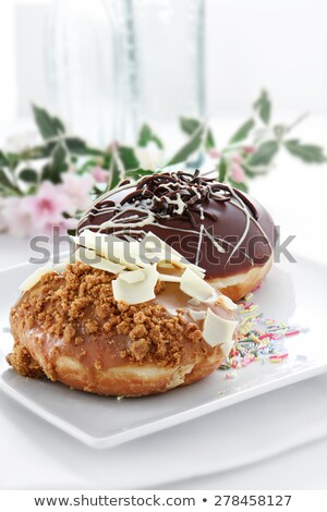 Stockfoto: Two Donuts Covered In Caramel And Chocolate Icing