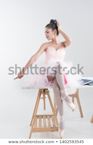 Сток-фото: The Young Ballerina Sitting On The Wooden Table