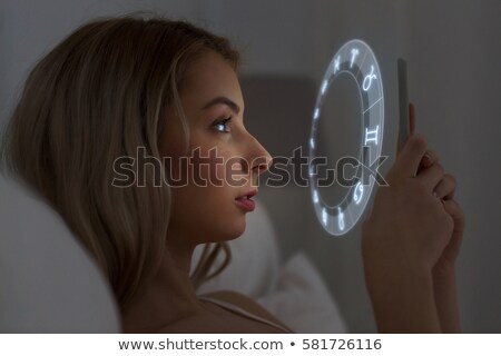 Zdjęcia stock: Young Woman Reading Horoscope On Smartphone