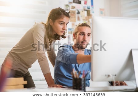 Foto stock: Young Man In Advertising Agency Designing On Computer